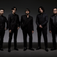 Members of the Ryu Ga Gotoku Studio team pose for the camera with all of them wearing black suits.
